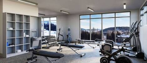 A modern gym with cardio equipment, weight benches, and dumbbells.