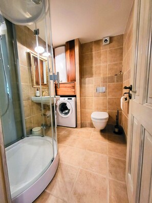 Shower, hair dryer, slippers, towels