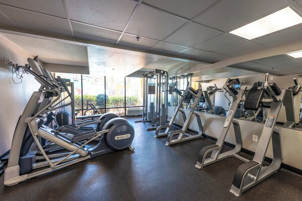 A gym with treadmills, ellipticals, and weight machines. - Caravelle 1044 (Myrtle Beach)