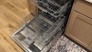 A kitchen with a dishwasher, a countertop, and a patterned rug. - 3-bedroom condo in Norton Commons (Prospect)