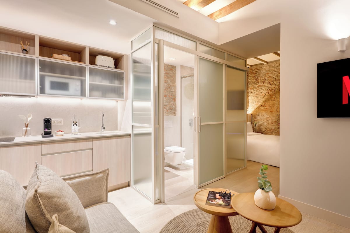 A modern interior with a kitchen, a living area, and a bathroom.