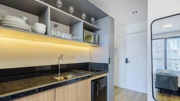 A modern kitchen with a built-in microwave, a sink, and a dishwasher.