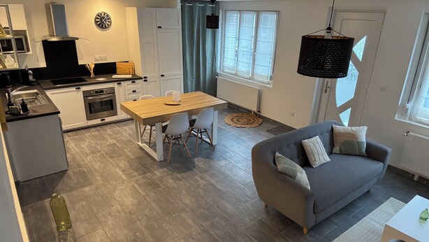 Un appartamento moderno con cucina, sala da pranzo e soggiorno.