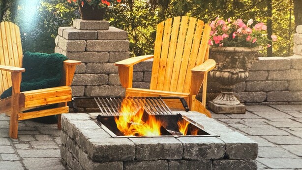 A stone fire pit with a metal grate, surrounded by wooden Adirondack chairs. - Charming 4-bedroom house with WiFi, AC in wonderful Scotrun (Scotrun)