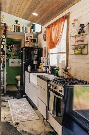 Fridge, microwave, coffee/tea maker, cookware/dishes/utensils
