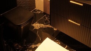 A modern bathroom with a marble floor, a black sink, and a towel rack. - MY SECRET (Torrox-Costa)