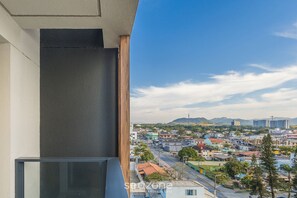 A balcony with a view of a cityscape, including buildings and mountains in the distance. - Studios With Side Sea View at Penha Spot PSO - L (Penha)