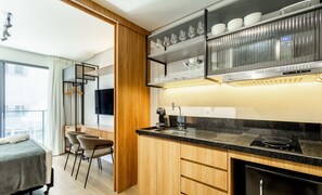 A modern kitchen with a built-in oven, a coffee machine, and a wine rack. - Studios With Side Sea View at Penha Spot PSO - L (Penha)