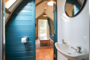 Een badkamer met een wastafel, toilet en spiegel.