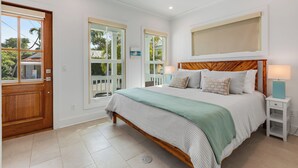 A bedroom with a wooden bed, a ceiling fan, and a window with a view of the outside. - SOUTHERN CROSS: 3 BR, 3.5 BA home in Old Town Key West with Private Pool & AC! (Key West)