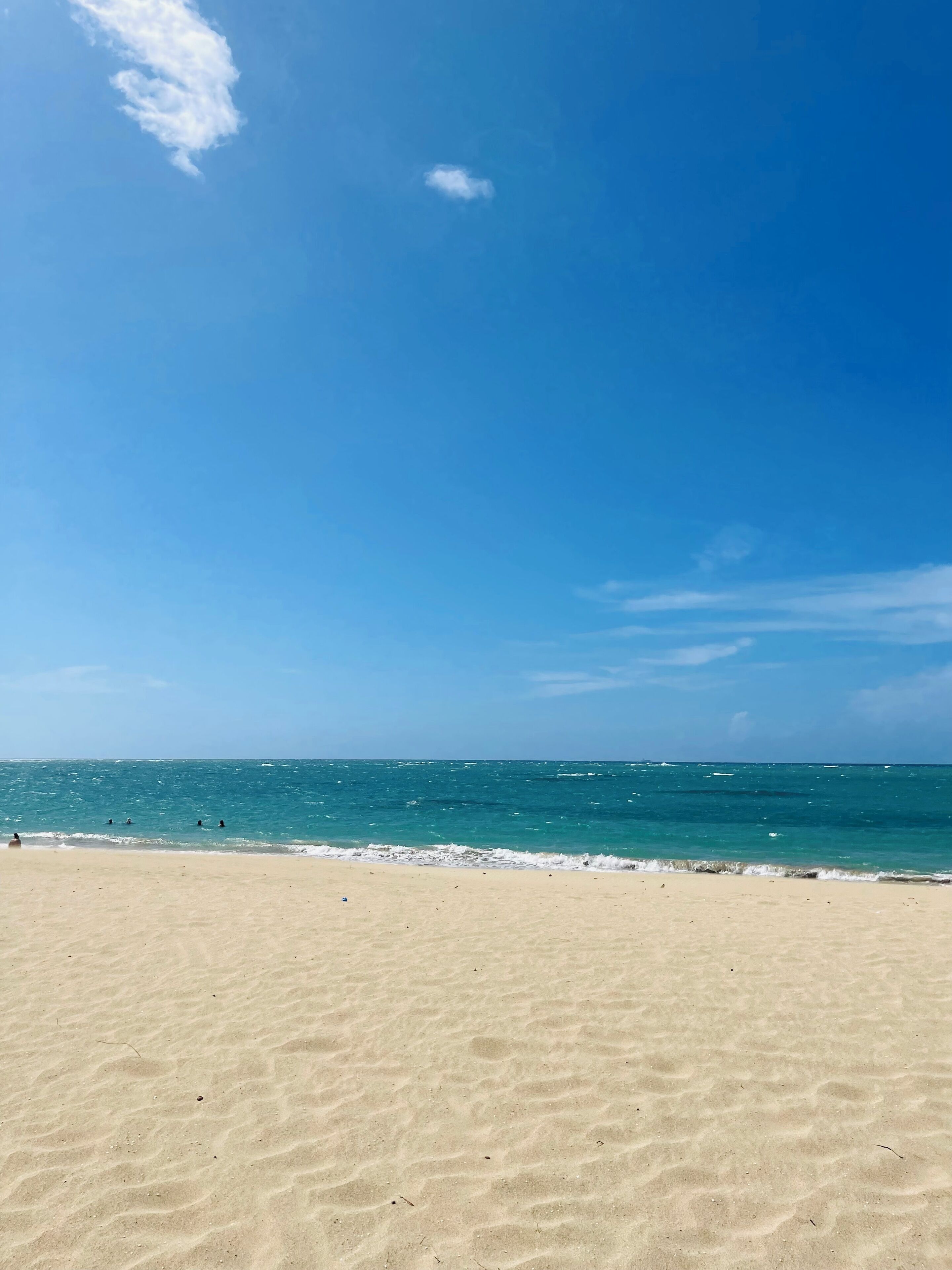 A beach with clear skies and calm sea.