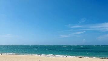 A beach with clear skies and calm sea.