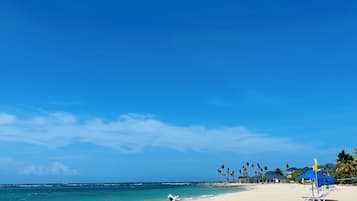 Private beach, white sand, sun loungers, beach umbrellas