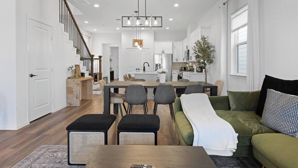 A modern kitchen with white cabinets, a central island, and pendant lighting. - Houston Family Retreat | Sleeps 10 | Near NRG (Houston)
