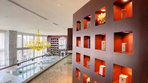A modern hotel lobby with a glass railing, a chandelier, and a marble floor. - ICON W BRICKELL COZY STUDIO #2205 (Miami)