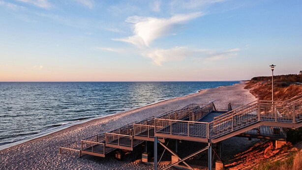 A coastal walkway with metal railings and a stone path leading to the beach. - 1 bedroom gorgeous home in Lazy (Lazy)