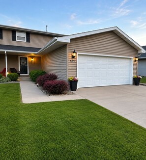A residential house with a garage, a well-maintained lawn, and a number '509' on the house.