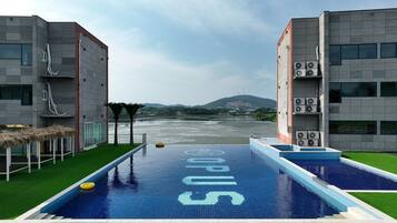 Seasonal outdoor pool, open 8:00 AM to 9:00 PM, pool umbrellas