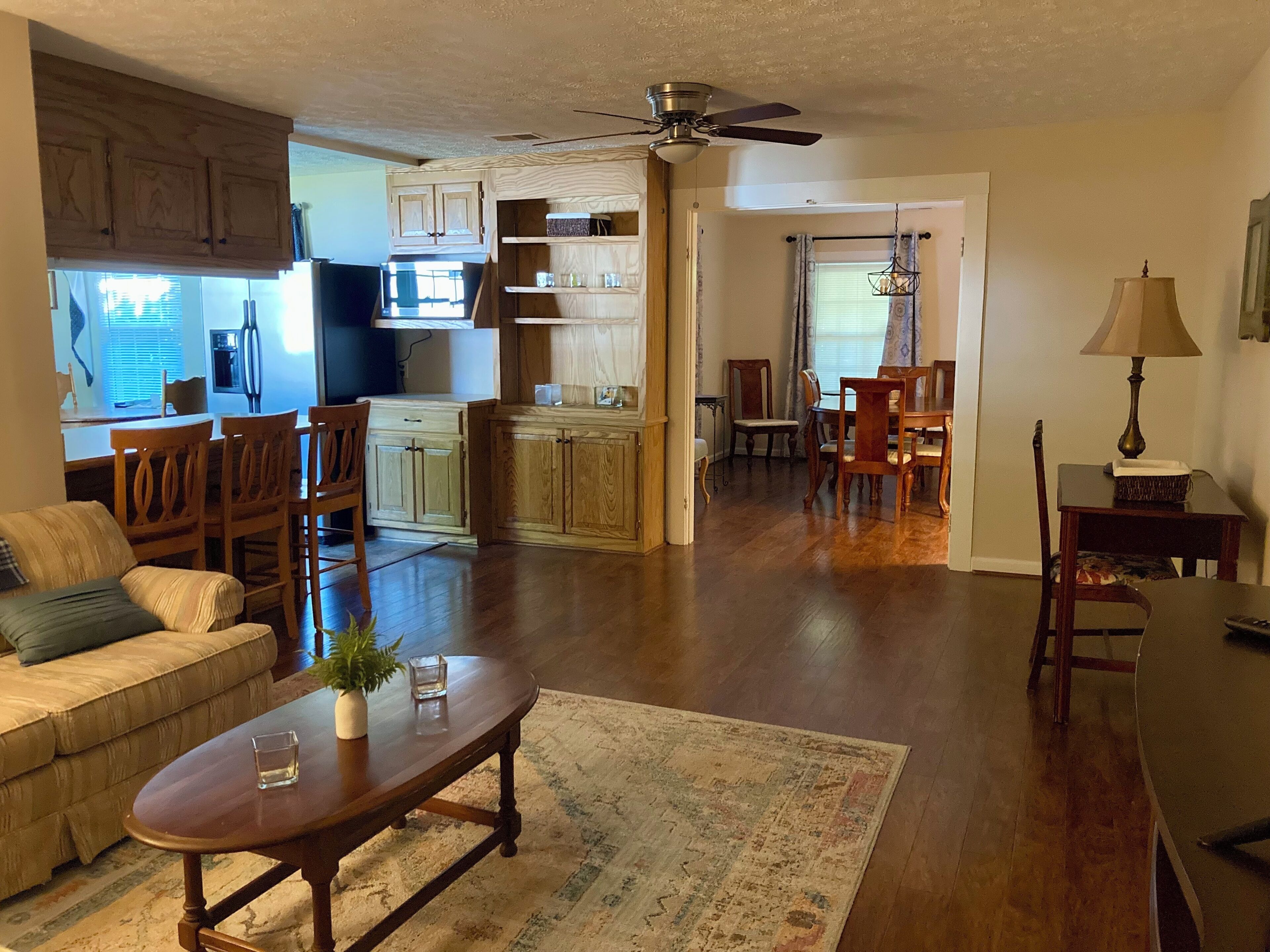 A spacious living room with a sofa, coffee table, and dining area.