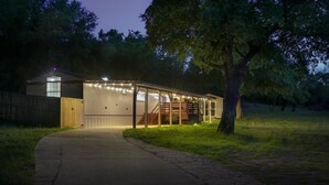 A house with a covered porch and a staircase leading to the entrance. - Gated Hill Country Escape: 1 Gb Internet & Seclusion (Spicewood)
