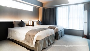 A modern hotel room with a large bed, a bedside table, a window with curtains, and a non-operable frosted glass window. - KIORI Hotel Higashino Toin (Kyoto)