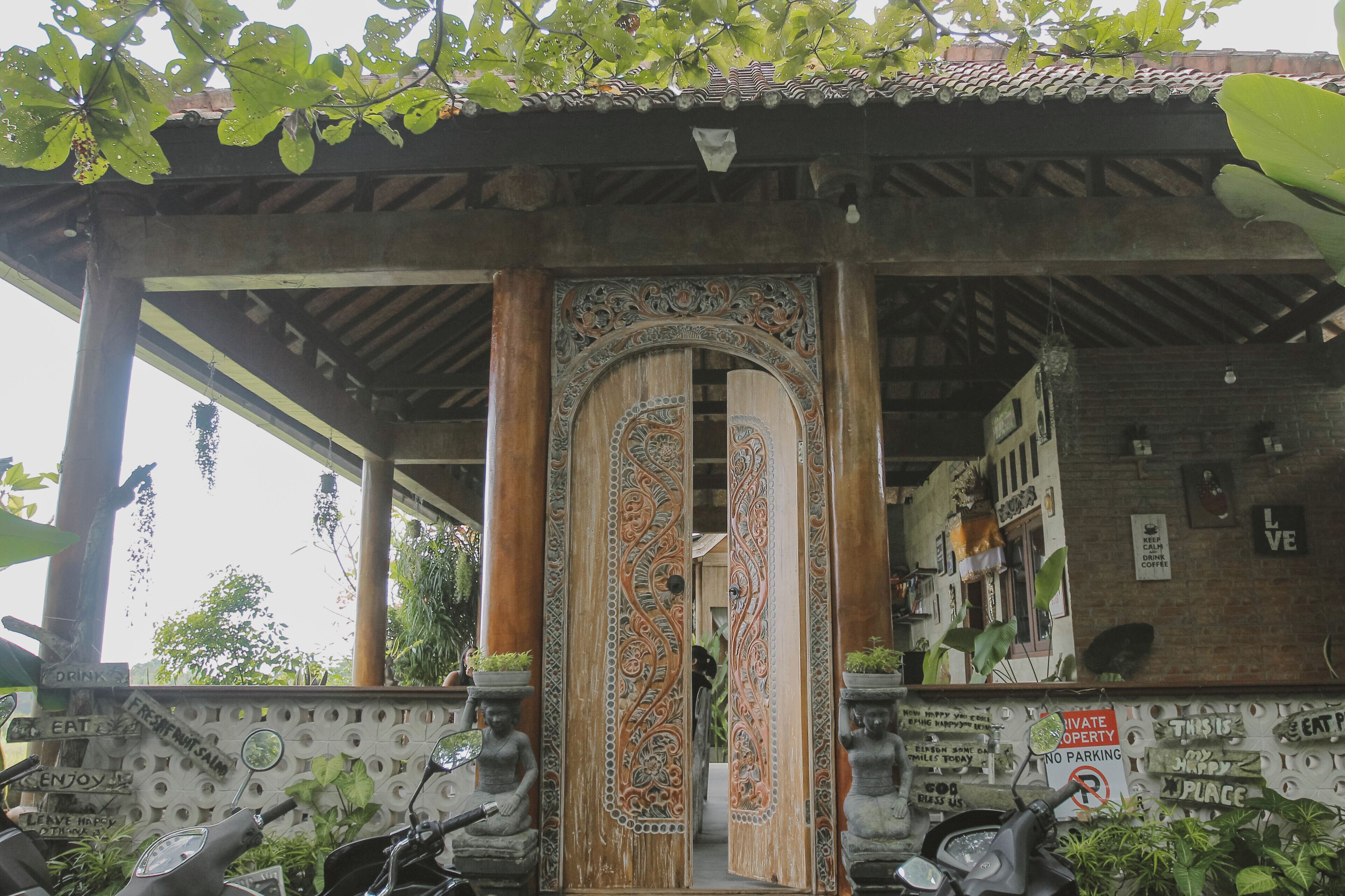 A traditional building with ornate wooden doors and a tiled roof.