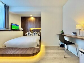 A modern hotel room with a bed, a desk, a television, and a window with curtains. - R34A9CC_903 / Koto-ku Tokyo (Koto-ku)