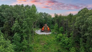 A cabin surrounded by dense forest with a gravel driveway leading to the entrance. - Romantic Sunsets Couples A Frame H/T Buffalo River (Parthenon)