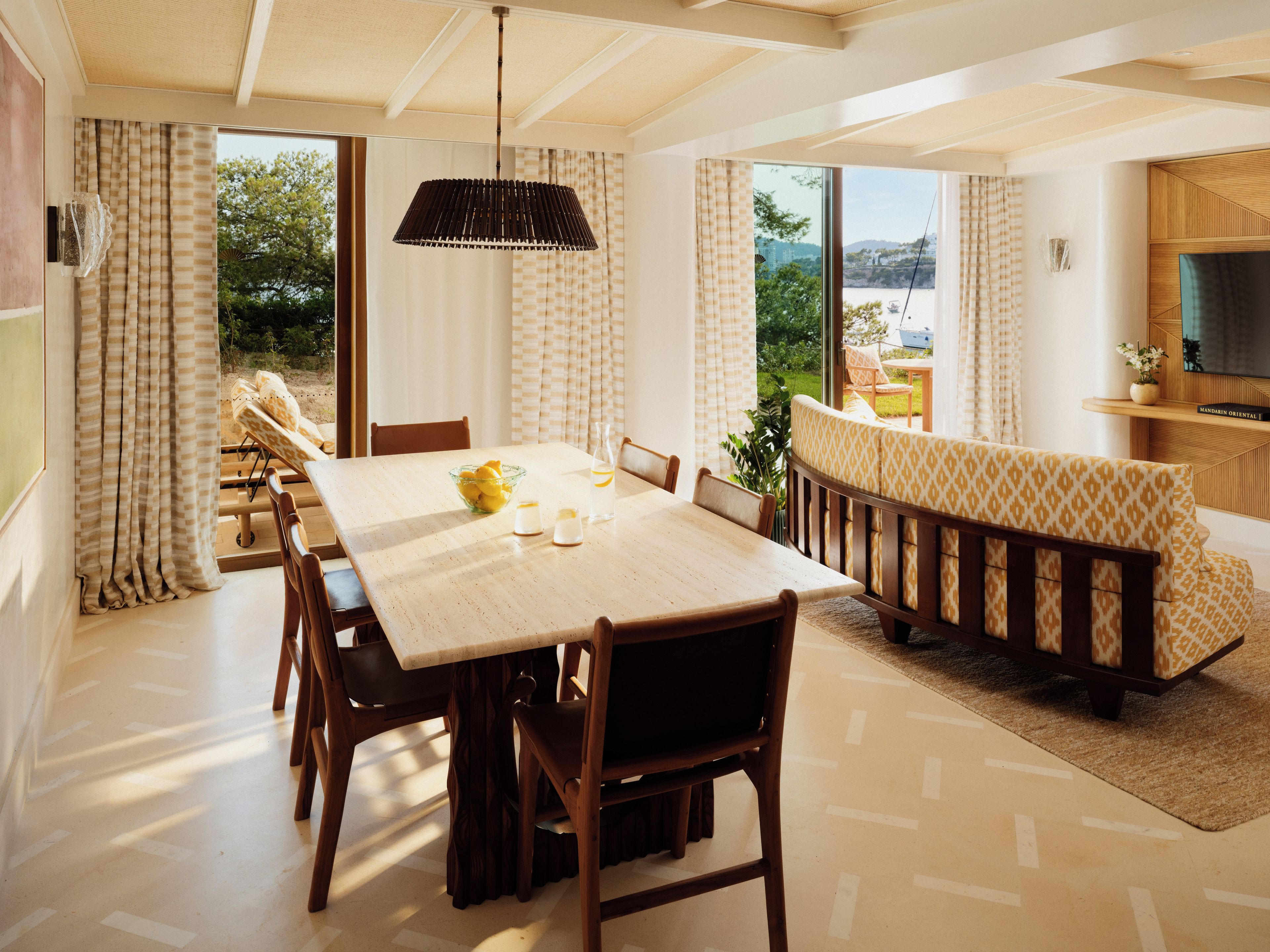 A dining area with a table, chairs, and a view of the outdoors.