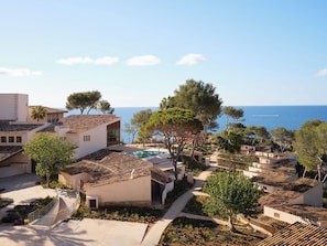 Une station balnéaire dotée d’une architecture méditerranéenne, d’une piscine et offrant une vue sur la mer.