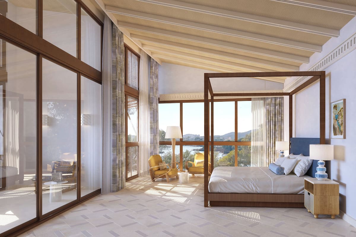 Un dormitorio espacioso con un gran ventanal, una cama con dosel y vistas al exterior.