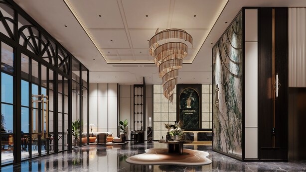 Un hall d’entrée spacieux avec un espace salon central, un lustre décoratif et un grand mur orné d’un motif évoquant le marbre.