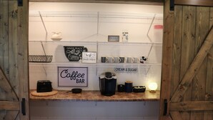 A coffee bar with a sign reading "Coffee Bar" and shelves labeled "Inner Peace with Caffeine" and "Cream & Sugar". - Mammoth Cave Cabin Rentals 12 (Mammoth Cave)