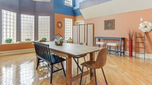 A spacious room with a wooden dining table, chairs, and a large window. - Downtown Apt: 23 Mi to Hocking Hills State Park (Lancaster)
