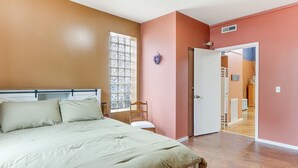 A bedroom with a bed, a window, a door, and a view into another room. - Downtown Apt: 23 Mi to Hocking Hills State Park (Lancaster)