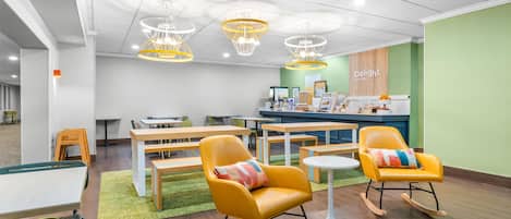 A modern interior with tables, chairs, and a counter area.