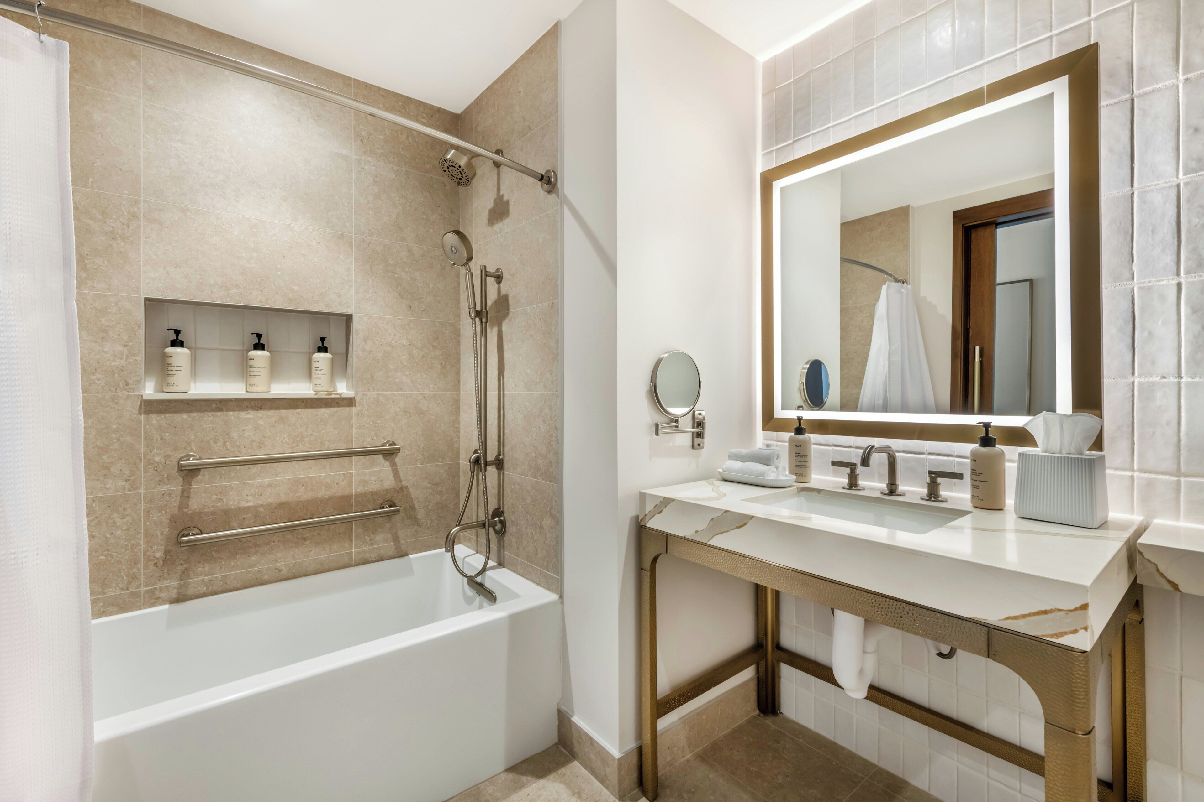 A modern bathroom with a bathtub, a vanity with a mirror, and a shelf with toiletries.