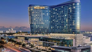 A modern hotel with a curved facade, multiple floors, and a prominent 'OMNI' sign.