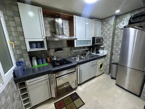 Departamento | Cocina privada | Refrigerador con congelador, microondas, horno y parrilla de estufa
