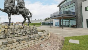 A modern building with a glass facade and a stone base. - Classic Lodge 38 (Rhyl)