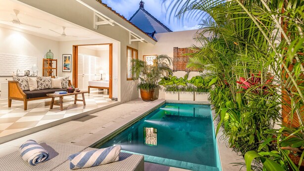 A modern house with a swimming pool, a dining area, and a living room with a sofa and a table. - Villa Zita (Seminyak)