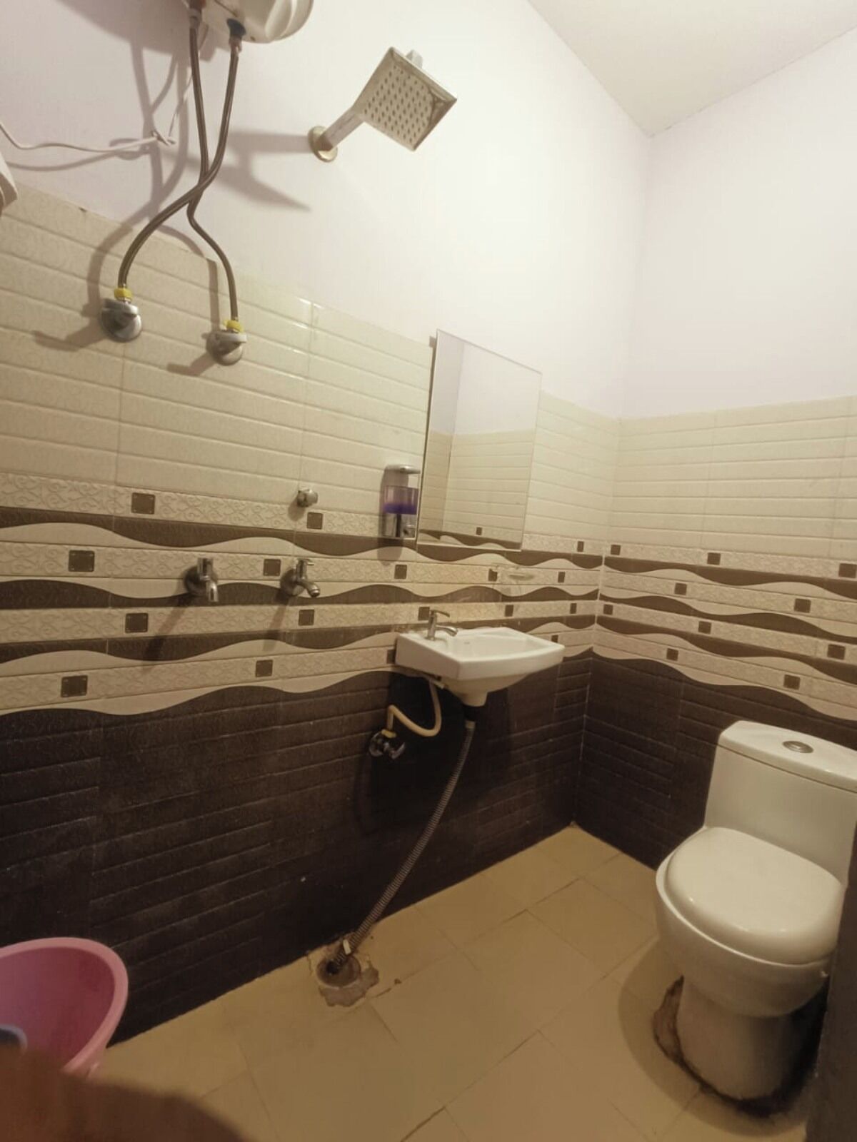 A bathroom with a shower, sink, and toilet.