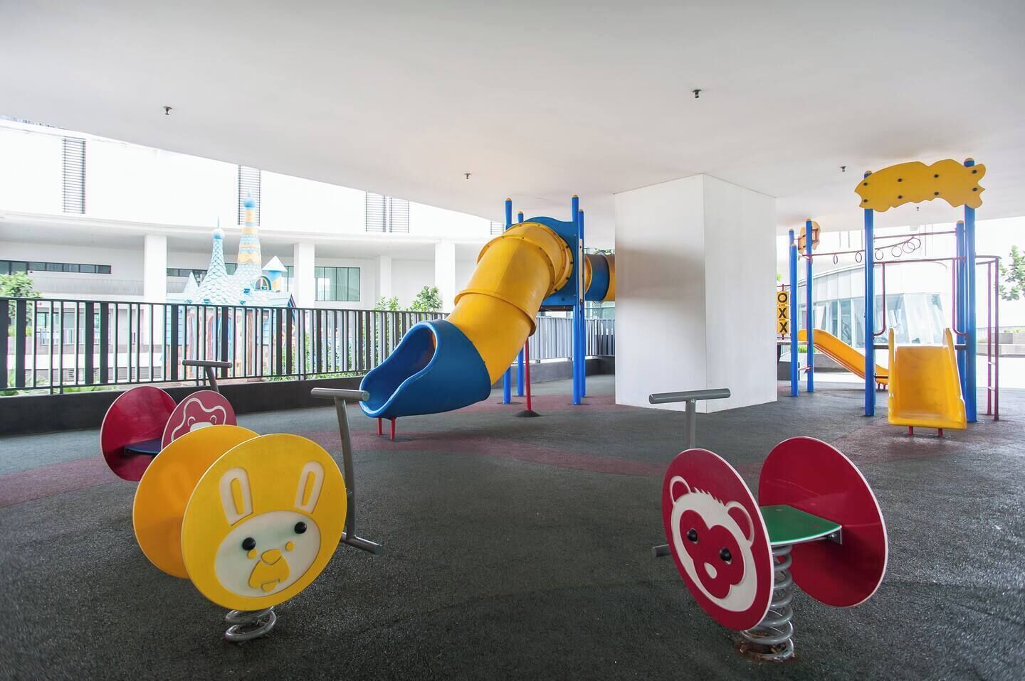A playground with a slide, swings, and colorful play equipment.