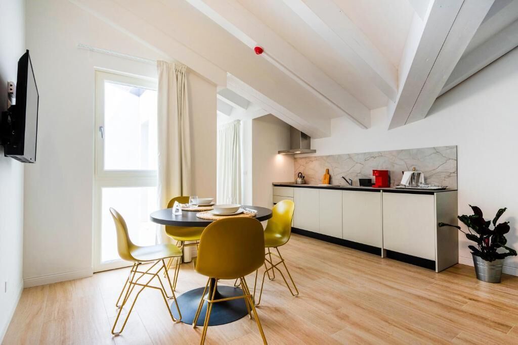 A modern kitchen with a dining area.