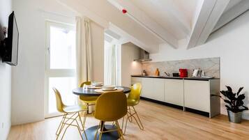 A modern kitchen with a dining area.