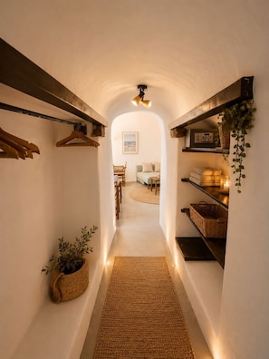 Family Cave Suite with Caldera View and Shared Pool | Living area | Printers - Lava suites (Fira)