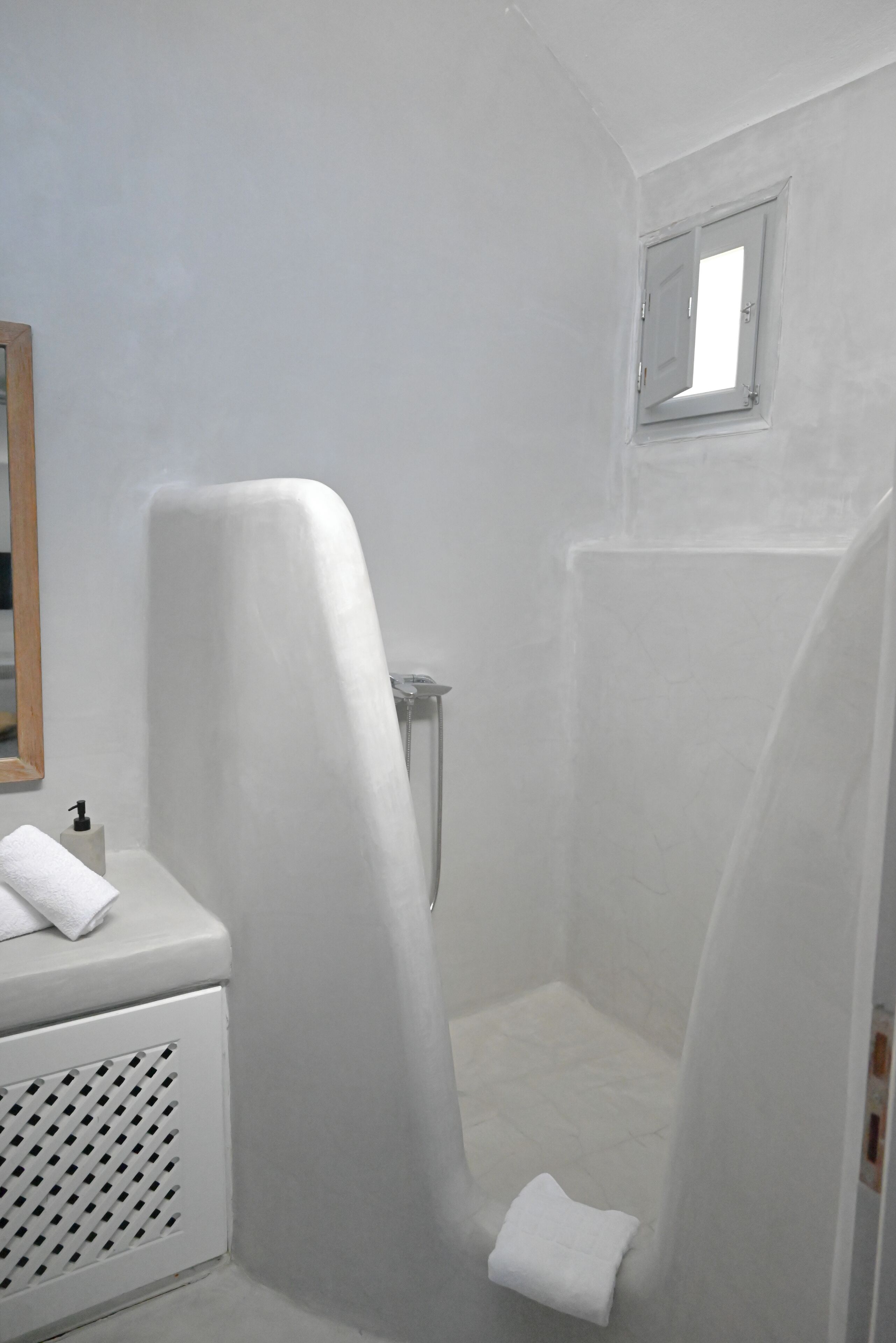 A bathroom with a shower, a toilet, and a sink.