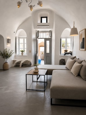 Family Cave Suite with Caldera View and Shared Pool | Living area | Printers - Lava suites (Fira)