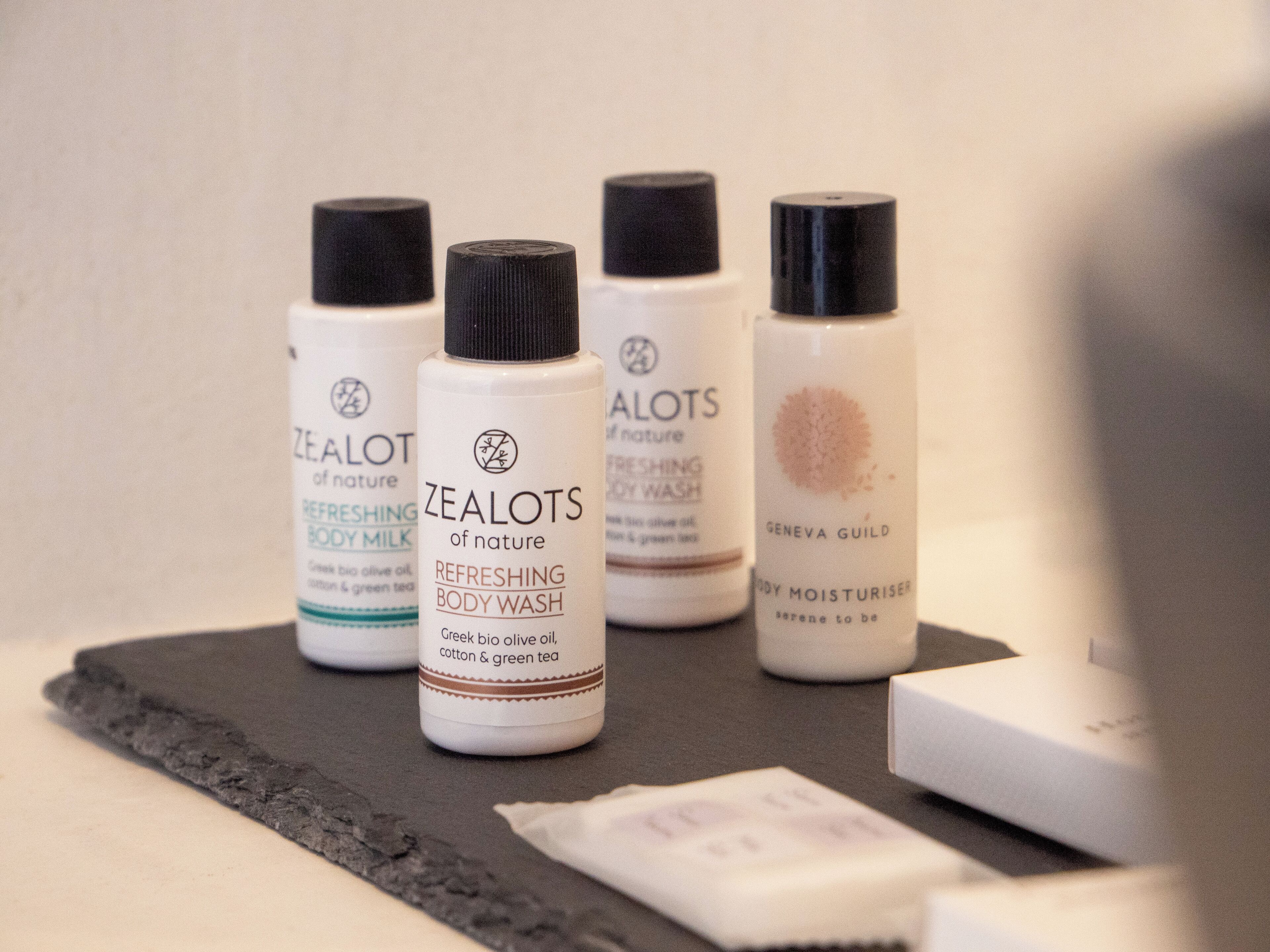 A selection of skincare products on a dark surface.