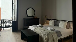 A bedroom with a bed, bedside table, dresser, mirror, and a window with a view. - Doña Perfecta -El 11 De López Botas-. (Las Palmas)